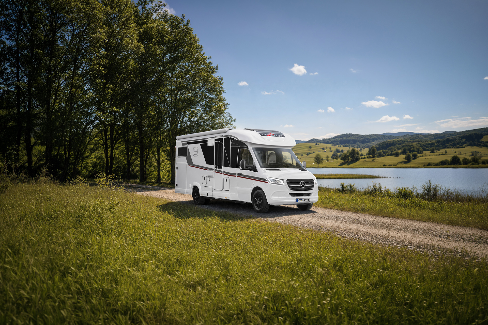 Carthago chic c-line T, teilintegriertes Wohnmobil auf einem Feldweg vor einer Seelandschaft